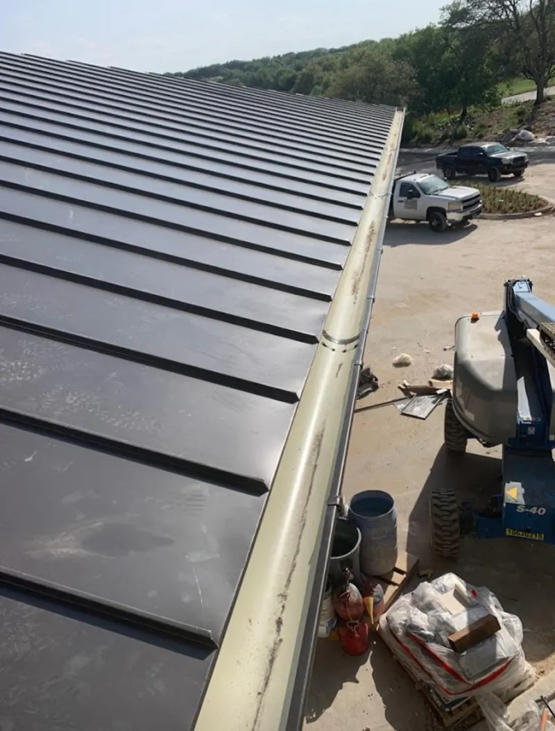 Standing seam panel and gutter detail on a metal roofing jobsite in Chillicothe